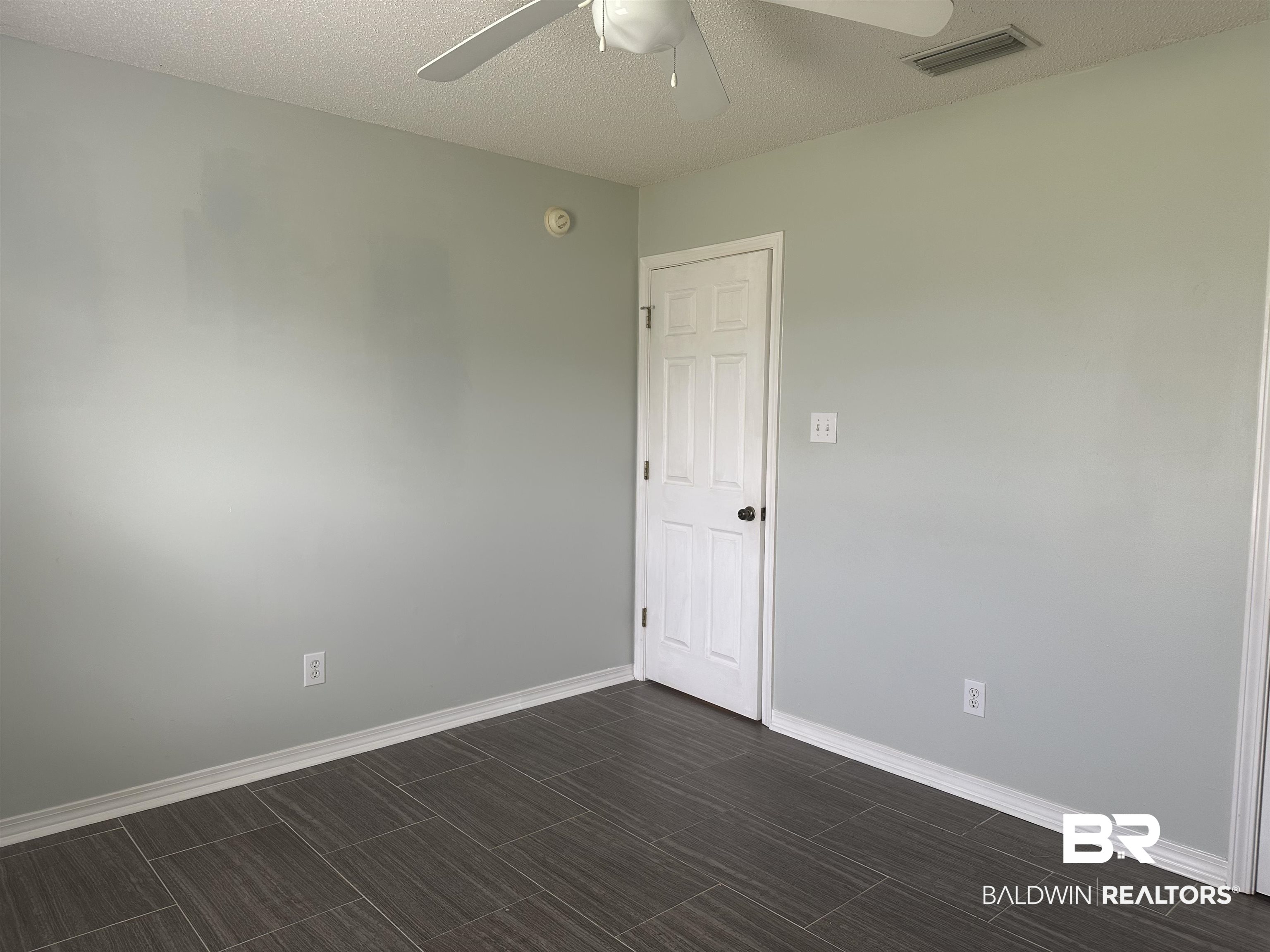 4882 Rebecca Place Mobile, AL 36695 - Photo 17 of 29 Spare room featuring visible vents, baseboards, wood tiled floor, a textured ceiling, and a ceiling fan