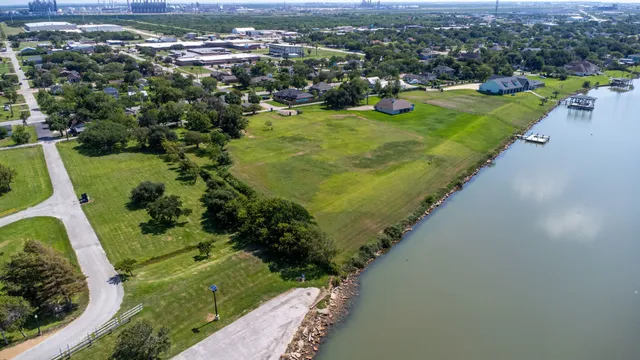 an aerial view of a house with a garden and lake view