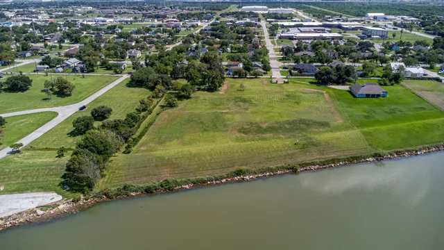 an aerial view of residential houses with outdoor space and swimming pool