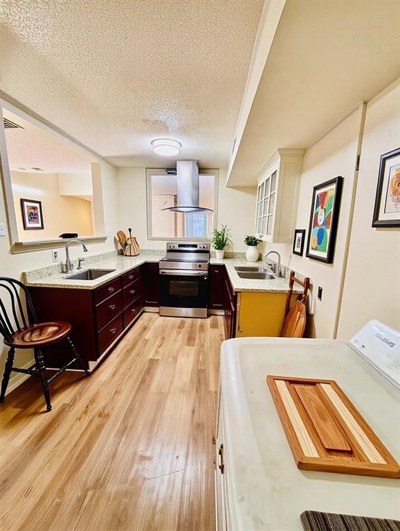 9696 Walnut Street, Unit 1305 Dallas, TX 75243 - Photo 11 of 25 a large kitchen with stainless steel appliances kitchen island granite countertop a sink and wooden floors