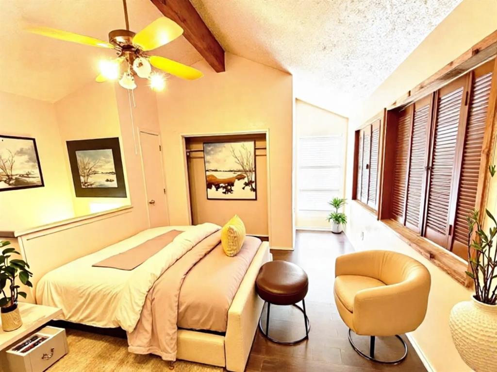 9696 Walnut Street, Unit 1305 Dallas, TX 75243 - Photo 17 of 25 a bedroom with a bed and a chandelier