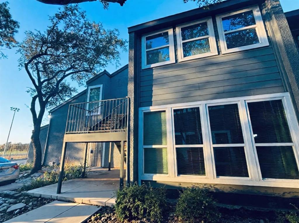 9696 Walnut Street, Unit 1305 Dallas, TX 75243 - Photo 2 of 25 a view of house with a window and wooden fence