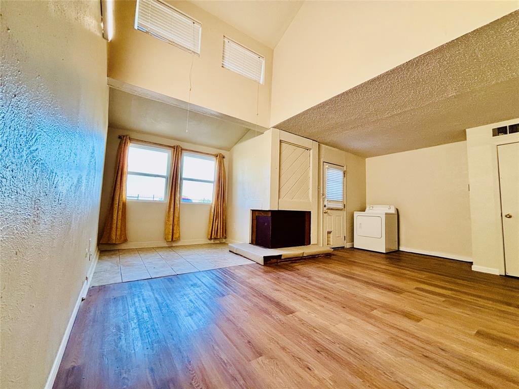 9696 Walnut Street, Unit 1305 Dallas, TX 75243 - Photo 5 of 25 a view of an empty room with wooden floor and a window