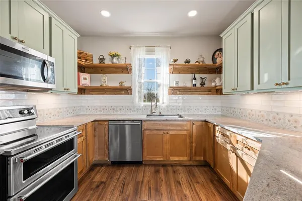 a kitchen with a sink stove and cabinets