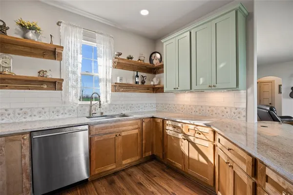 a kitchen with cabinets stainless steel appliances and a sink