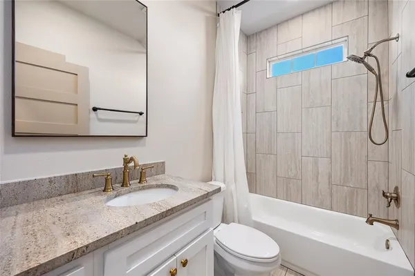 a view of a room with wooden floor and a window