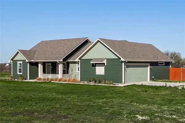 a front view of house with yard and green space