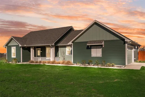 a front view of house with yard and green space