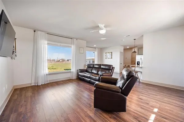 a living room with furniture and a wooden floor