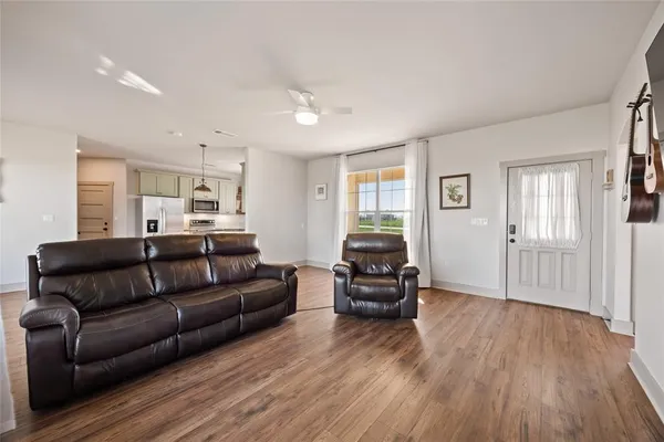a living room with furniture window and wooden floor