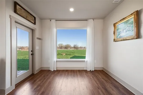 a view of front door with wooden floor