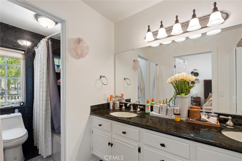 31256 Quail Valley Road Castaic, CA 91384 - Photo 4 of 16 a bathroom with a sink a large mirror and a toilet