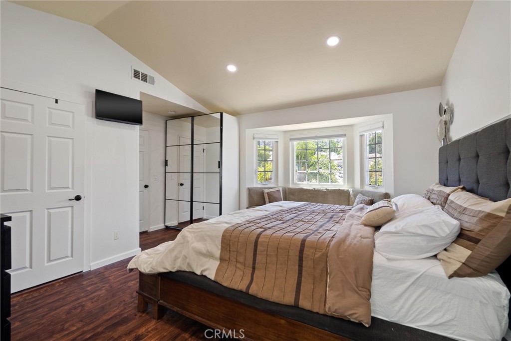 31256 Quail Valley Road Castaic, CA 91384 - Photo 9 of 16 a bedroom with a large bed a flat tv screen and a closet