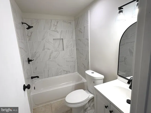 a bathroom with a toilet a sink and bathtub