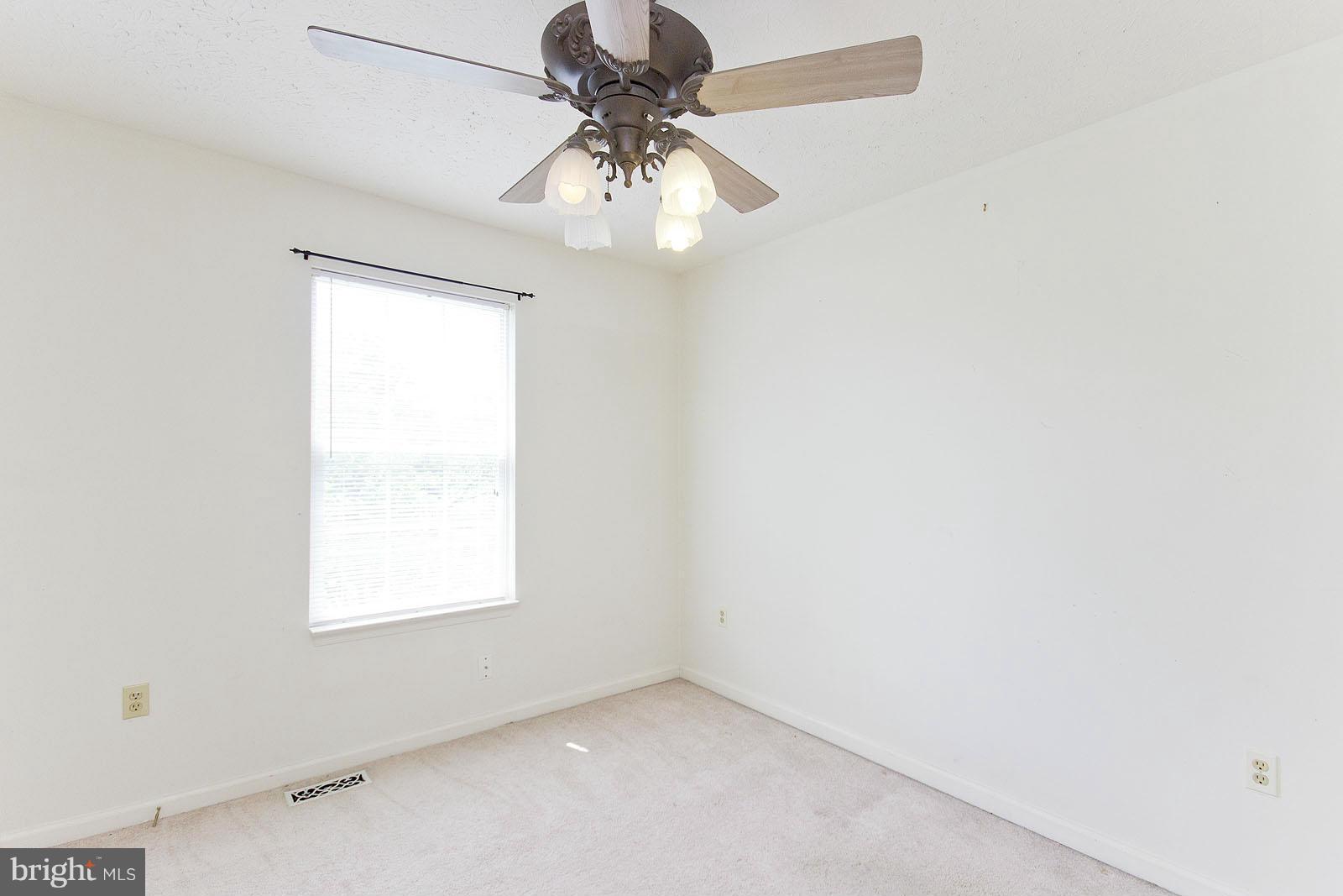 138 Charlton Road Winchester, VA 22602 - Photo 13 of 30 an empty room with a window and a fan