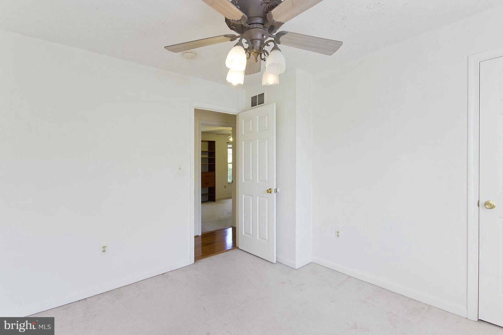 138 Charlton Road Winchester, VA 22602 - Photo 14 of 30 an empty room with a chandelier fan and closet