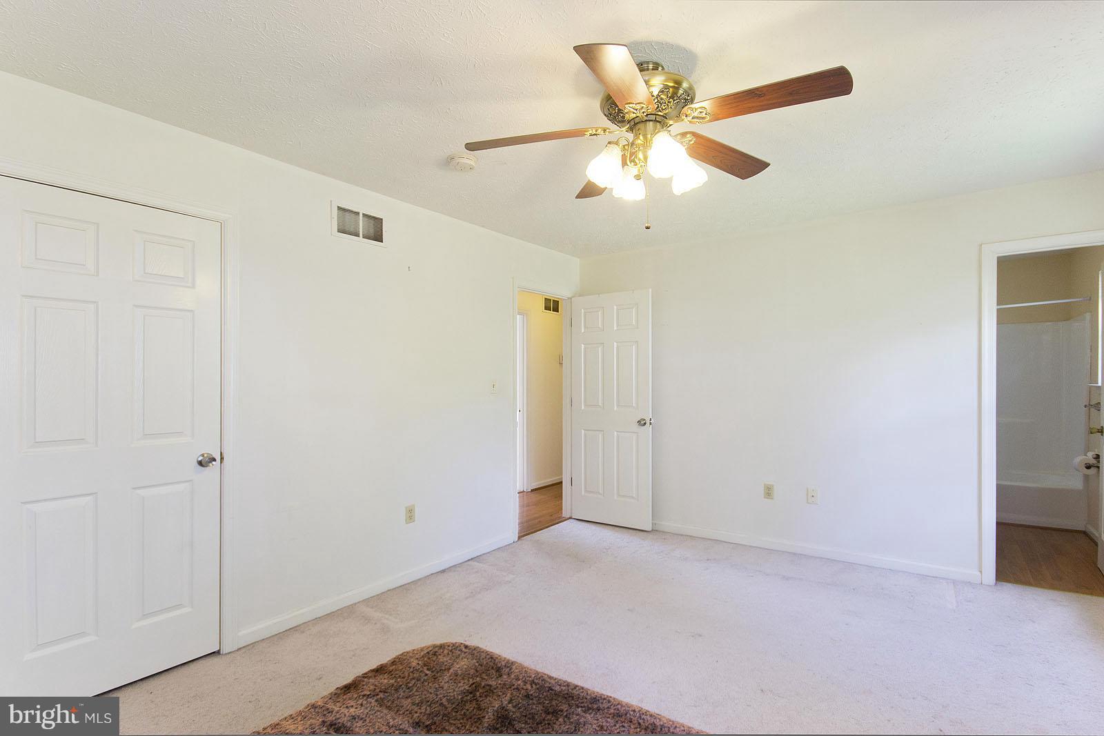 138 Charlton Road Winchester, VA 22602 - Photo 17 of 30 a view of an empty room with a ceiling fan