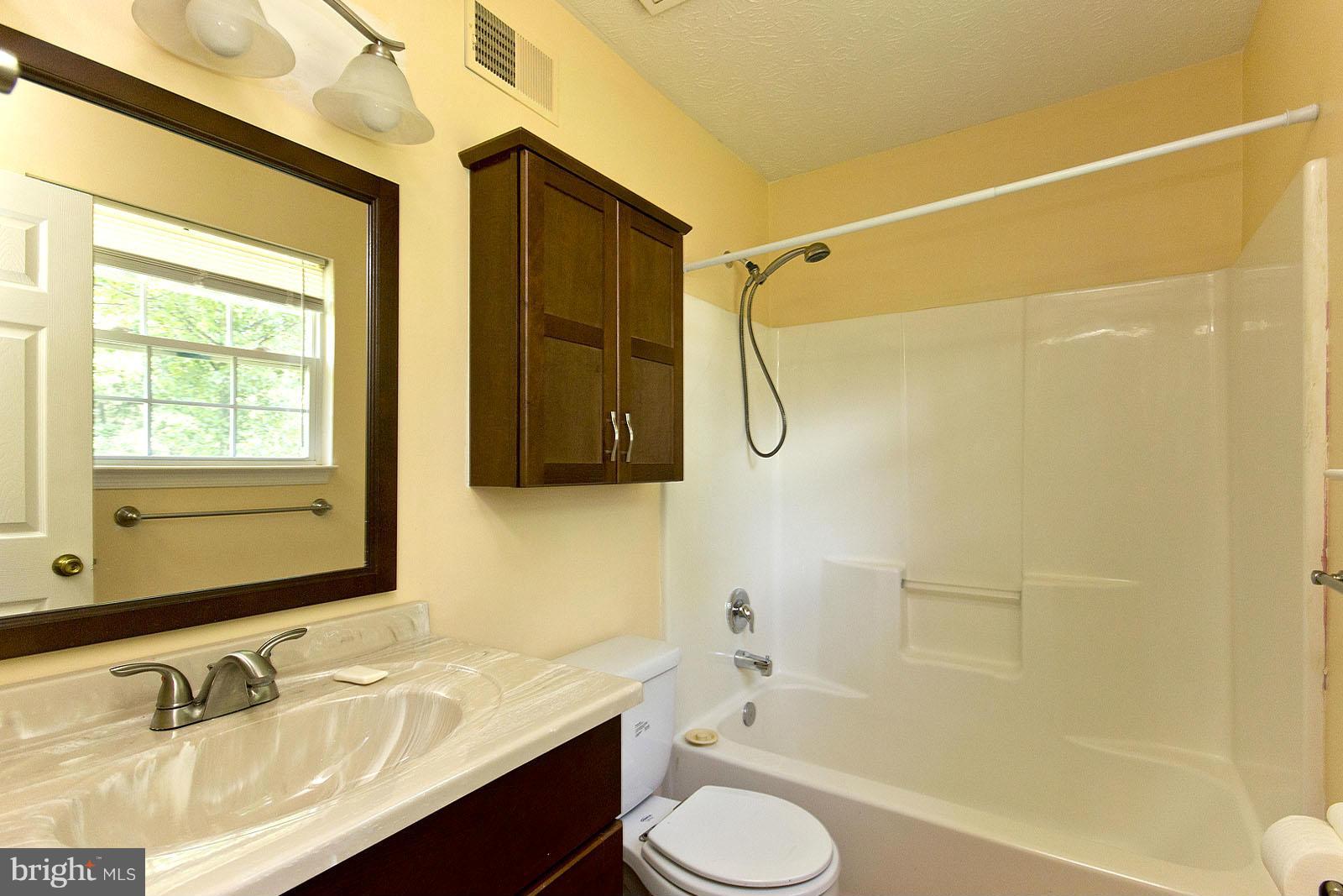 138 Charlton Road Winchester, VA 22602 - Photo 18 of 30 a bathroom with a granite countertop sink toilet and shower