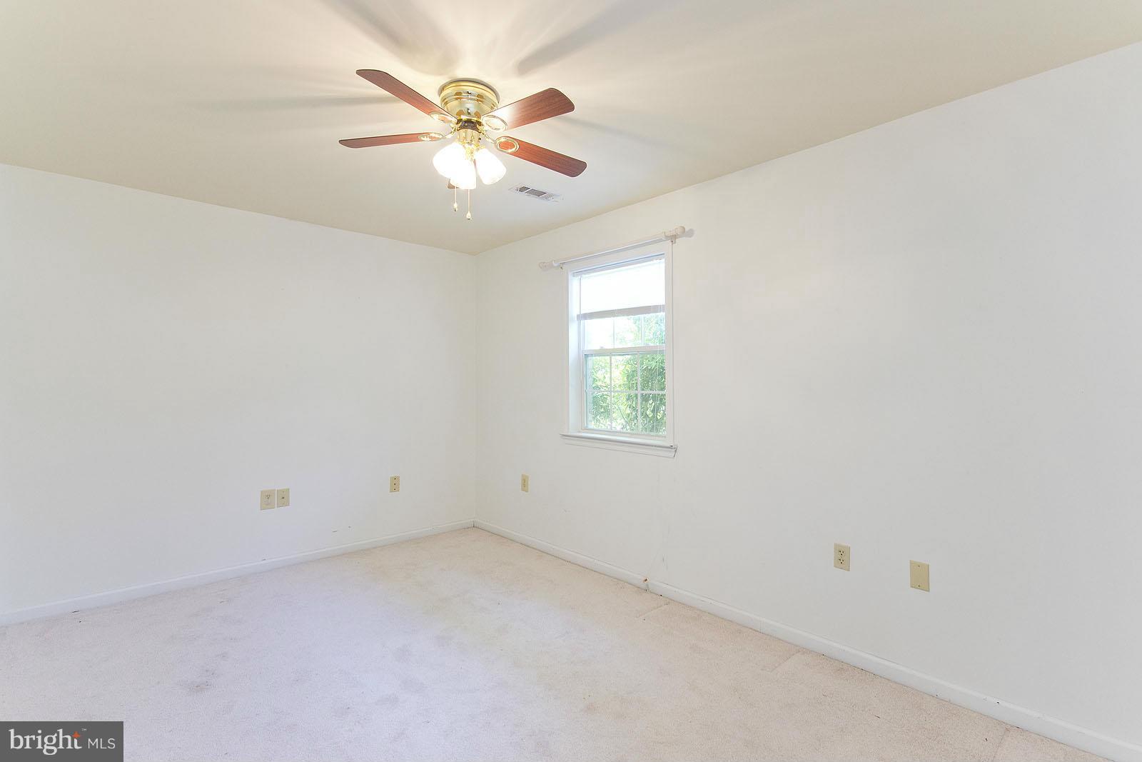 138 Charlton Road Winchester, VA 22602 - Photo 24 of 30 an empty room with a window and a fan