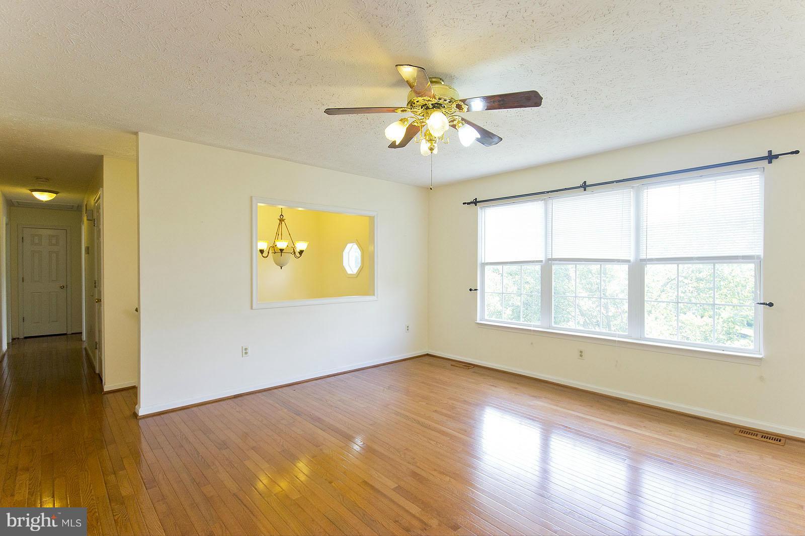 138 Charlton Road Winchester, VA 22602 - Photo 4 of 30 a view of an empty room with wooden floor and a window