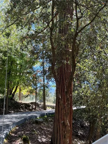 a view of a living room with a large window and wooden floor