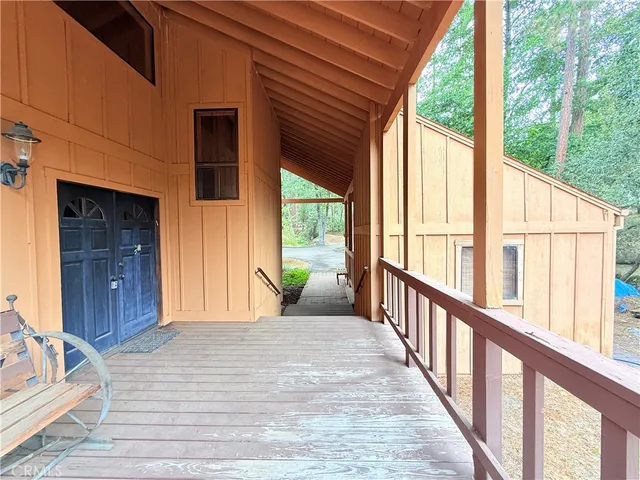 a view of a porch with wooden floor and stairs