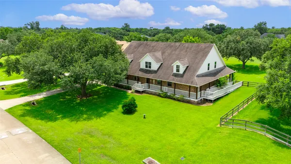 an aerial view of a house with a big yard
