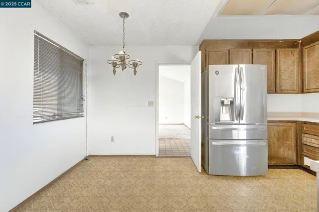 a kitchen with stainless steel appliances a refrigerator and a refrigerator