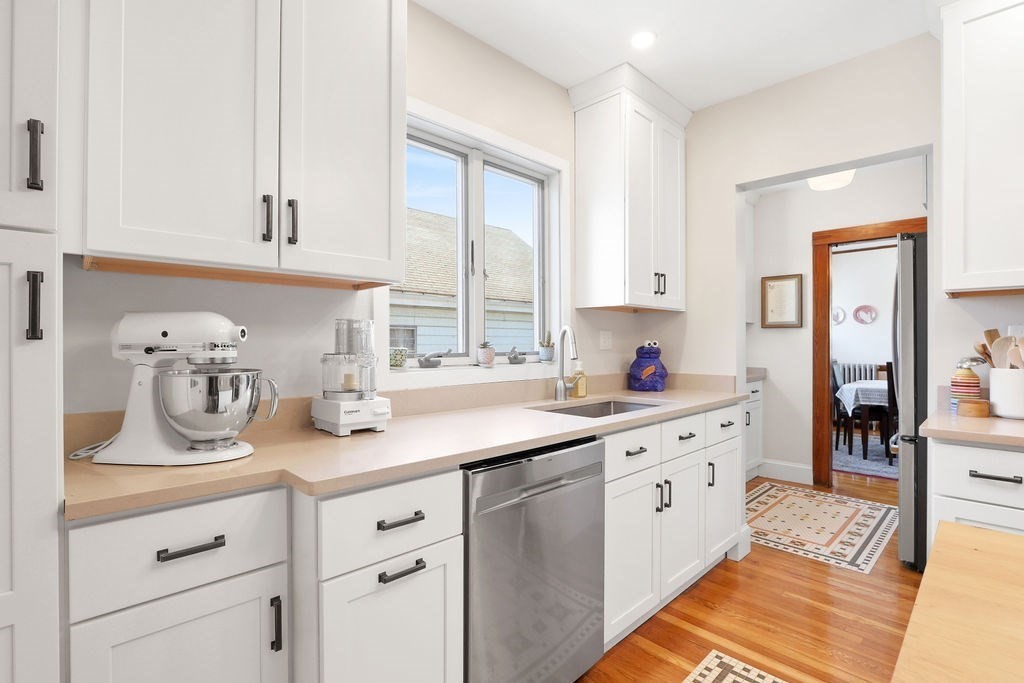 43-45 Owencroft Road, Unit 2 Boston, MA 02124 - Photo 11 of 36 a kitchen with cabinets appliances a sink and a window