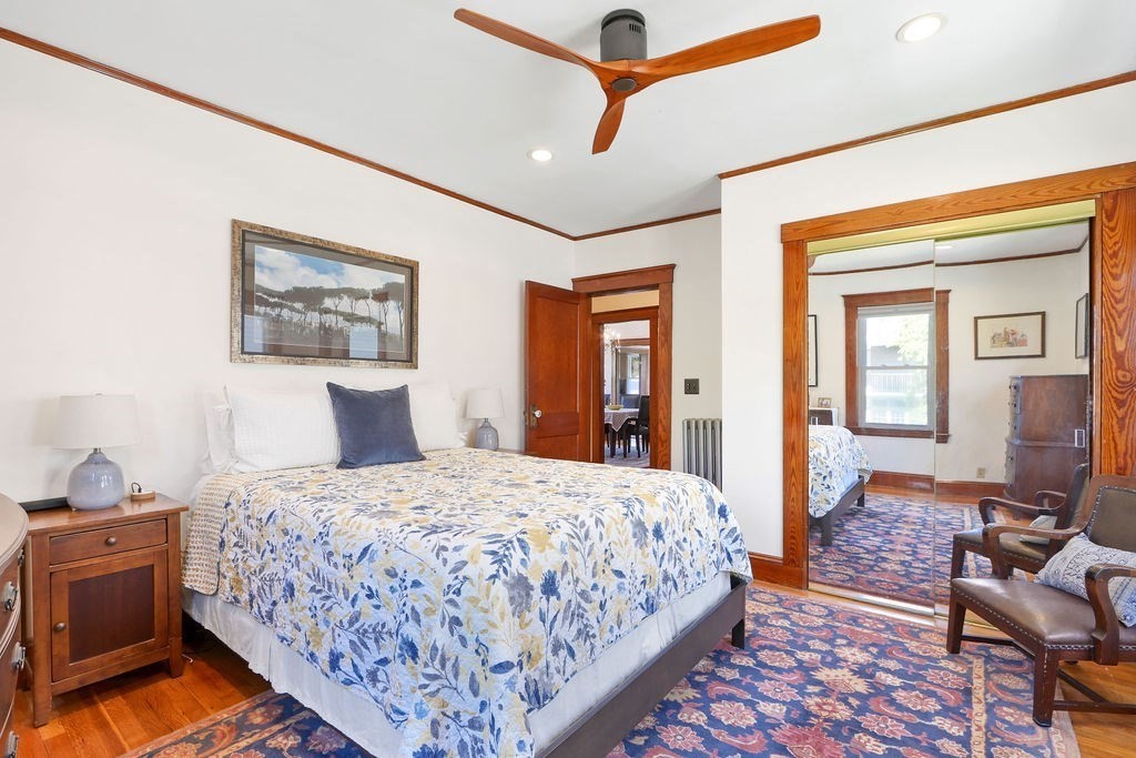 43-45 Owencroft Road, Unit 2 Boston, MA 02124 - Photo 17 of 36 a bedroom with a bed and wooden floor