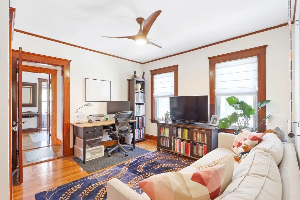 43-45 Owencroft Road, Unit 2 Boston, MA 02124 - Photo 19 of 36 a living room with furniture a flat screen tv and a floor to ceiling window