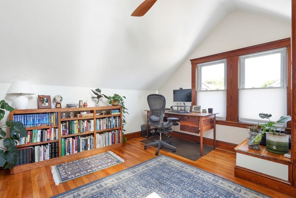 43-45 Owencroft Road, Unit 2 Boston, MA 02124 - Photo 21 of 36 a living room with furniture a rug and a book shelf