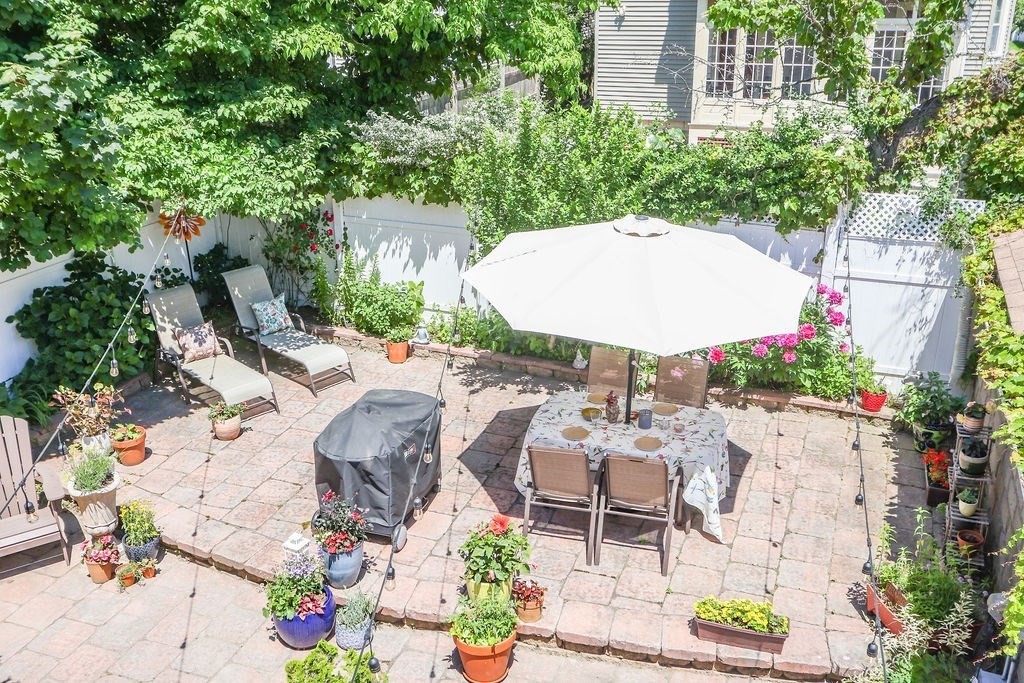 43-45 Owencroft Road, Unit 2 Boston, MA 02124 - Photo 28 of 36 an aerial view of a house with a yard and sitting area