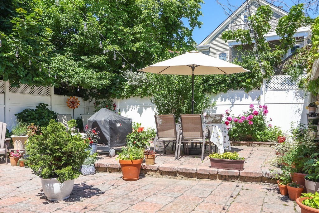 43-45 Owencroft Road, Unit 2 Boston, MA 02124 - Photo 29 of 36 an outdoor space with furniture and umbrella