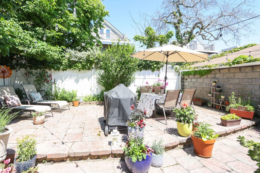 43-45 Owencroft Road, Unit 2 Boston, MA 02124 - Photo 32 of 36 a view of a backyard with sitting area