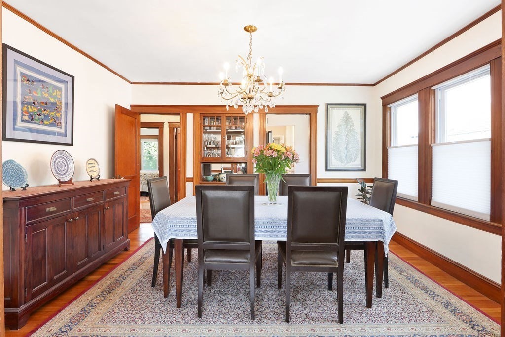43-45 Owencroft Road, Unit 2 Boston, MA 02124 - Photo 8 of 36 a dining room with furniture a chandelier and wooden floor