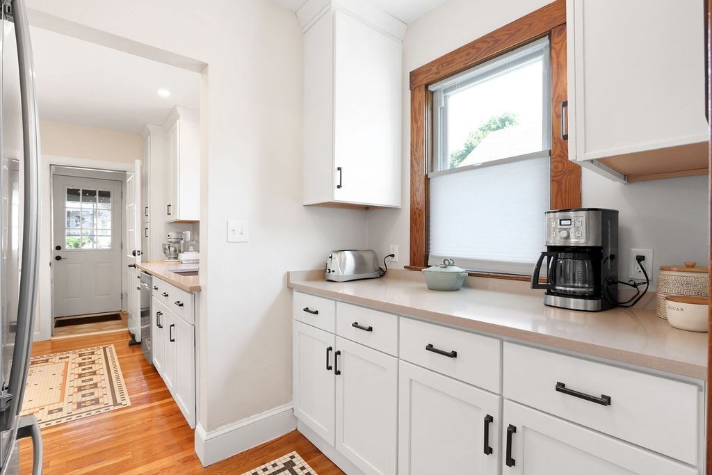 43-45 Owencroft Road, Unit 2 Boston, MA 02124 - Photo 10 of 36 a kitchen with stainless steel appliances white cabinets and a window