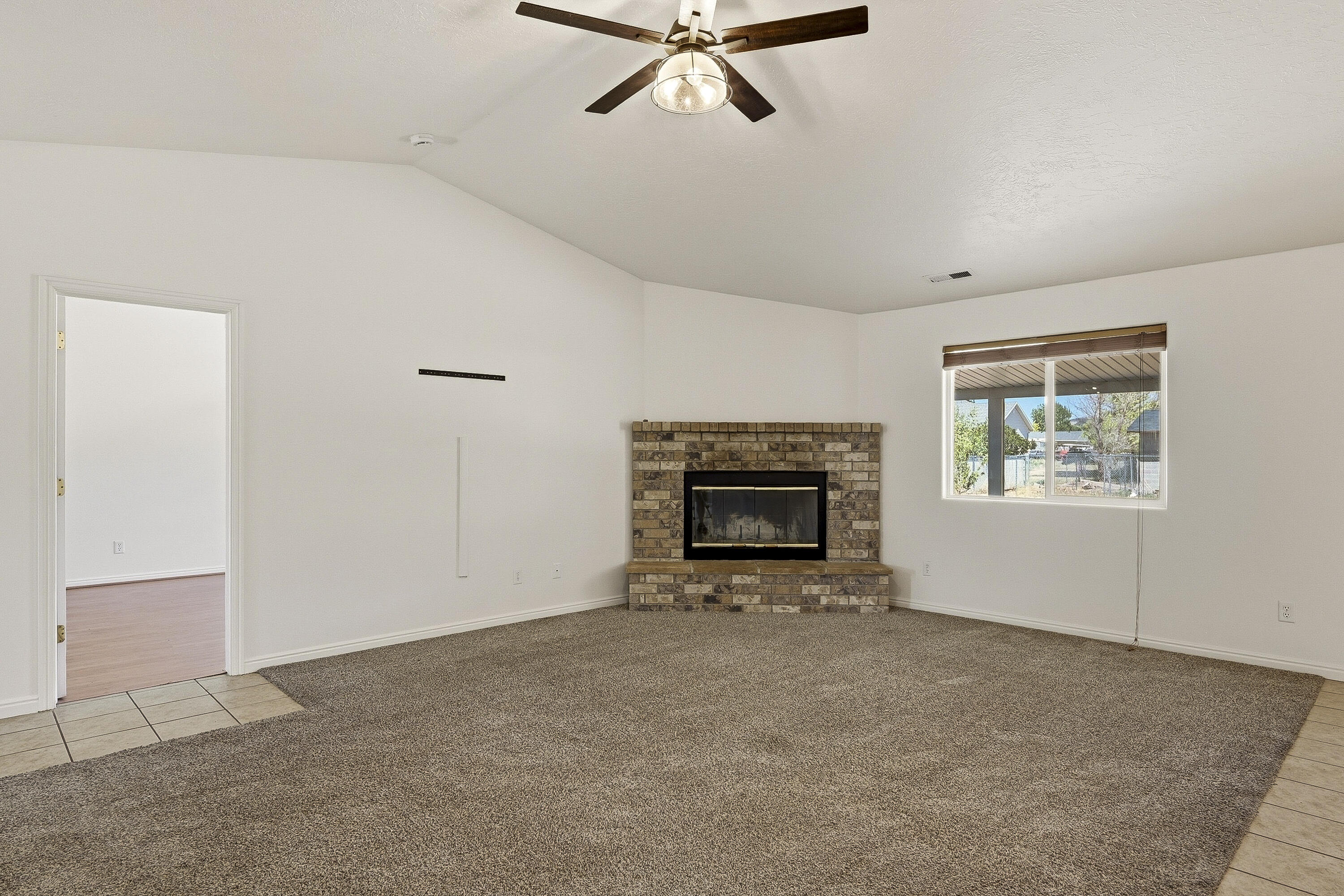 4510 North Half Mile Road Cedar City, UT 84721 - Photo 6 of 48 A wood-burning fireplace creates a welcoming atmosphere and serves as the focal point of the living room.