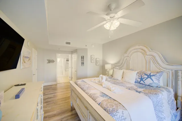 a bedroom with a large bed and a flat screen tv