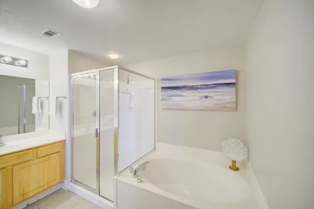 a bathroom with a tub a sink and a shower