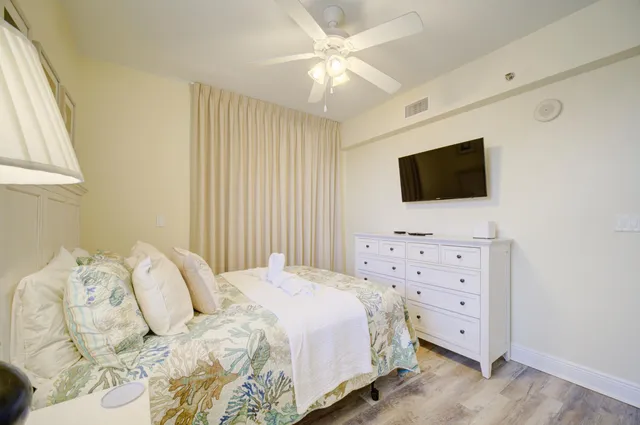 a bedroom with a bed and a flat screen tv