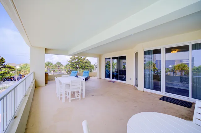 a dining room with furniture and a floor to ceiling window