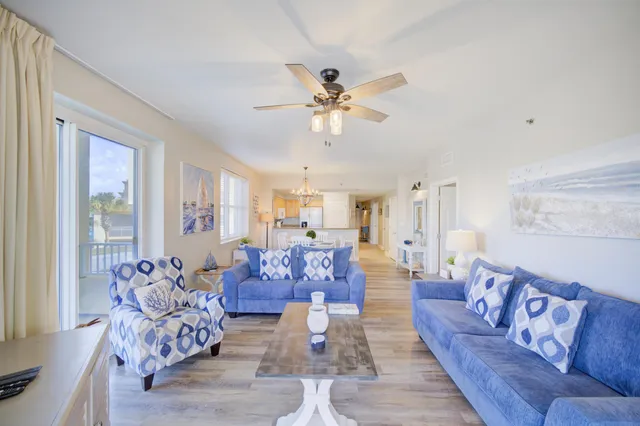 a living room with furniture or chandelier and a wooden floor