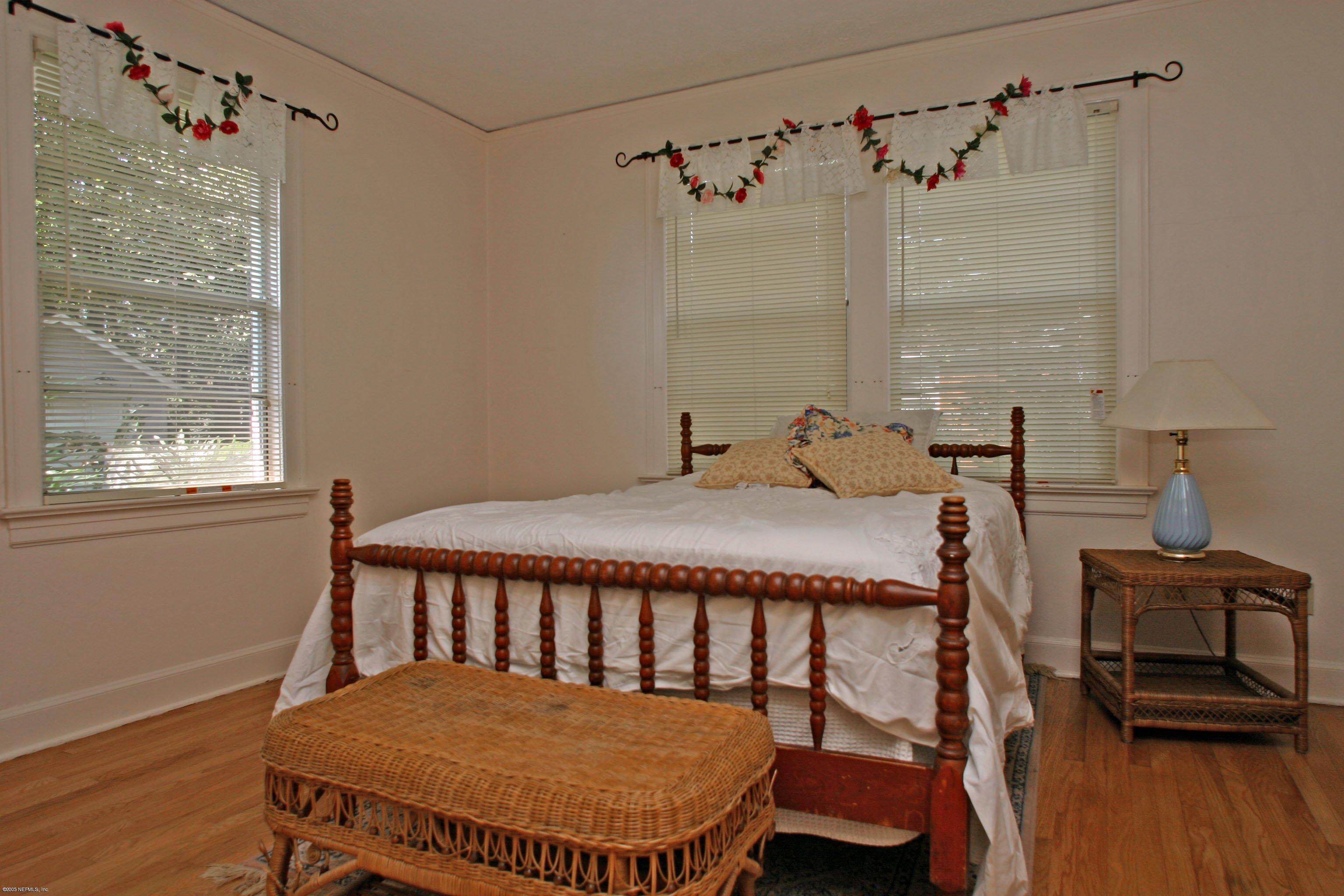 1510 Nicholson Road Jacksonville, FL 32207 - Photo 8 of 14 a bedroom with a bed and a table in it