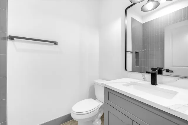 a bathroom with a sink toilet and mirror