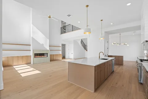 a kitchen with kitchen island a sink and a stove top oven