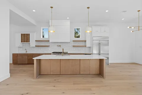 an open kitchen with a sink and cabinets