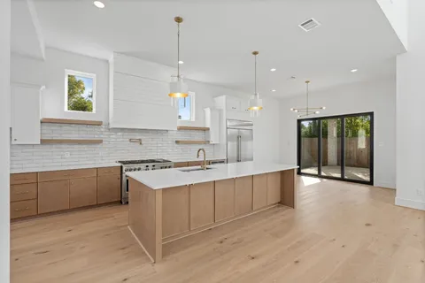 a view of a kitchen with a sink and a window