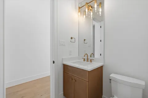 a view of a large kitchen with a sink and natural light