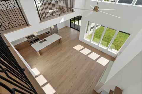 a view of a kitchen with wooden floor and a window